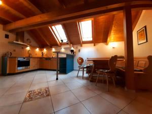 a kitchen with wooden ceilings and a table and chairs at Apartment Jutta by Interhome in Guttenberg