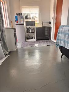 a kitchen with a floor that has a crack in it at Cape Comfy Hidden Home in Cravenby +3 photos
