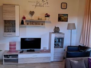 a living room with a flat screen tv on a table at Apartment FeWo Steinbeisser by Interhome in Arrach
