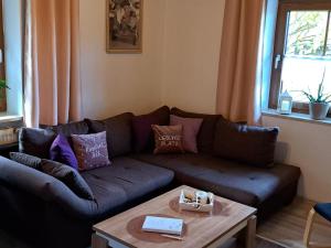 a living room with a couch and a coffee table at Apartment FeWo Steinbeisser by Interhome in Arrach