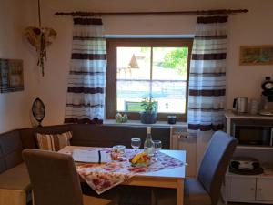 a table and chairs with a table and a window at Apartment FeWo Steinbeisser by Interhome in Arrach