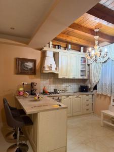 a kitchen with white cabinets and a counter top at B&B temptation in CTA
