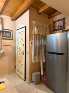 a kitchen with a refrigerator and a window at B&B temptation in CTA