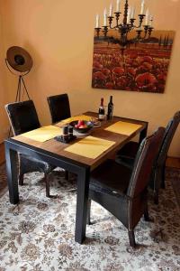 a dining room table with chairs and a dining room at Apartment mit Pool by Interhome in Bad Schmiedeberg