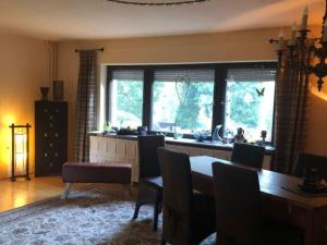 a dining room with a table and chairs and a window at Apartment mit Pool by Interhome in Bad Schmiedeberg +7 photos