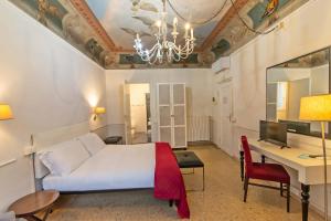 a bedroom with a bed and a desk with a computer at Duomo View in Florence