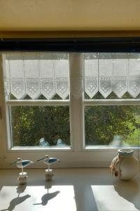 a window in a kitchen with two chairs in front of it at Apartment Mooij Plaats by Interhome in Großefehn 