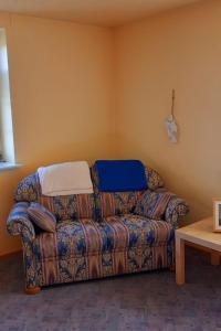 a living room with a couch with a blanket at Apartment Mooij Plaats by Interhome in Großefehn  +7 photos
