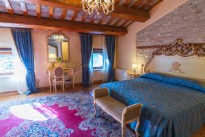 a bedroom with a bed and a chair and a table at Villa Rinalducci in Fano +63 photos
