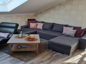 a living room with a blue couch and a coffee table at Apartment FeWo Steinbeisser by Interhome in Arrach