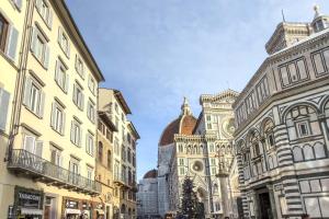 a group of buildings in a street with a church at Duomo View in Florence