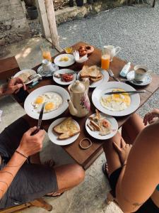 a group of people sitting around a table eating breakfast at Costal View-Ahangama in Ahangama