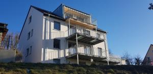 a white building with balconies on the side of it at Ferienwohnung Schwalbenflug in Naumburg
