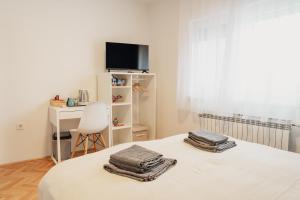 a bedroom with a bed with two towels on it at Vanjkuš in Marija Bistrica