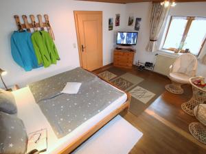 a room with a bed and a tv in it at Apartment Bärli by Interhome in Bad Bayersoien