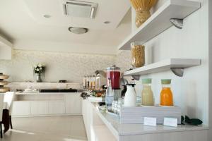 a kitchen with a counter with many bottles on it at Hotel Life in Rimini