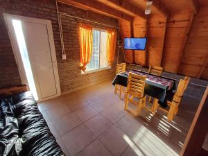 a living room with a table and a couch at Cabañas Amapola del 66 in Miramar