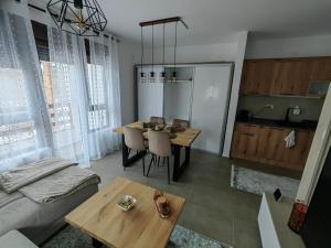 a living room with a table and a couch at Vidak apartman in Divčibare +16 photos