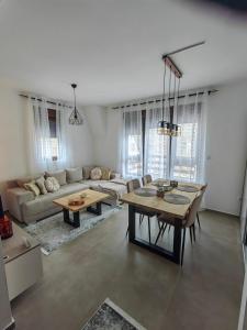 a living room with a couch and a table at Vidak apartman in Divčibare