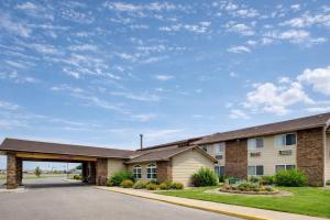 a large brick building with a garage at Fireside Inn and Suites in Devils Lake