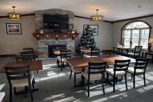 a dining room with a christmas tree and a fireplace at Fireside Inn and Suites in Devils Lake