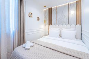 a bedroom with a white bed with white pillows at Garbo hotel in Paris