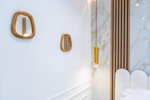 a bathroom with a glass door with a mirror at Garbo hotel in Paris +2 photos