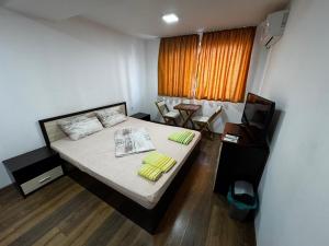 a bedroom with a bed with two towels on it at Dunav Apart in Ruse