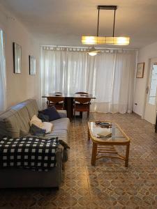a living room with a couch and a table at La Casa del bosque in Valencia