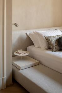 a bed with a side table next to a bed at Hotel Trame in Rome