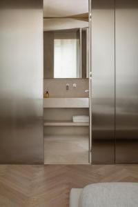a bathroom with a mirror and a sink at Hotel Trame in Rome