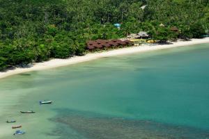 two boats in the water next to a beach at PingChan Koh Phangan Beachfront Resort in Thong Nai Pan Yai