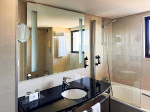 a bathroom with a sink and a shower at Hotel Vila Galé Cascais T1 542 weeks 34 & 35 every year in Cascais +12 photos