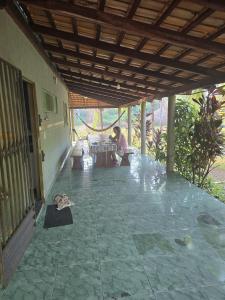 a person sitting at a table on a patio at RECANTO DO SABIÁ in Carolina +95 photos