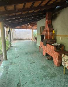 a patio with a brick fireplace in a house at RECANTO DO SABIÁ in Carolina