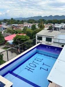 a swimming pool with a view of a city at Hotel ZT in Mariquita
