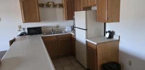 a kitchen with a white refrigerator and a sink at Bayview Inn in Crescent City +37 photos