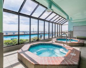 a jacuzzi tub in a large room with windows at Phoenix X 811 in Orange Beach +36 photos
