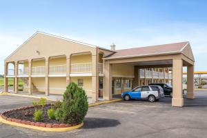 a building with a car parked in a parking lot at Red Lion Inn & Suites Junction City in Junction City