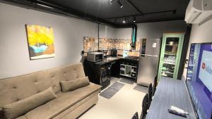 a room with a couch and a table and a kitchen at Studio de Praia in Matinhos