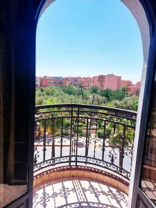 a balcony with a view of a park at Hotel redouane in Marrakech