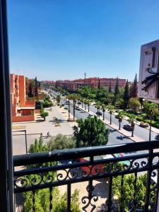 a view of a city from a balcony at Hotel redouane in Marrakech