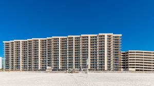 a large apartment building on the beach with the sand at Phoenix X 809 in Orange Beach