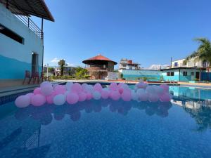 a bunch of pink and white balloons in a swimming pool at Universal Bliss in Pokhara +7 photos