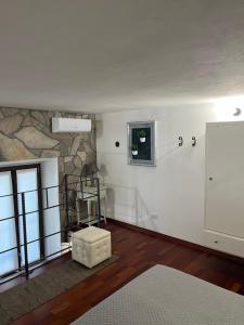 a living room with a stone wall and a window at Rent Room Sardegna in Porto Torres