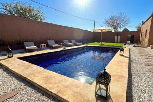 a swimming pool in the backyard of a house at Villa Léa in Marrakesh