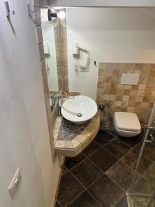 a bathroom with a sink and a toilet at Rent Room Sardegna in Porto Torres