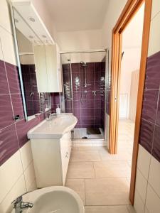 a bathroom with a toilet and a sink and a shower at Supramonte Guesthouse in Agropoli