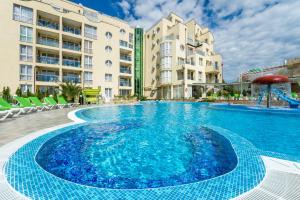 a large swimming pool in front of some buildings at Apart Hotel Vechna R in Sunny Beach