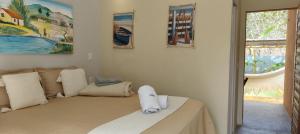 una camera da letto con un letto con cuscini bianchi di Vila Pescador Fortim a Fortim